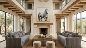 Living room with gray sofas, a coffee table, and a horse painting on the wall.