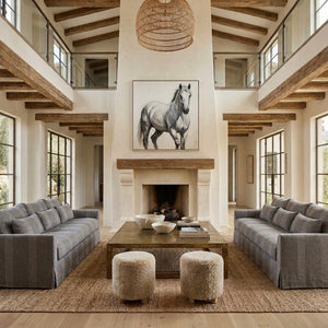 Living room with gray sofas, a coffee table, and a horse painting on the wall.