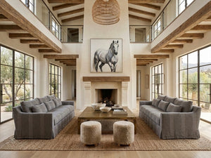 Living room with gray sofas, a coffee table, and a horse painting on the wall.