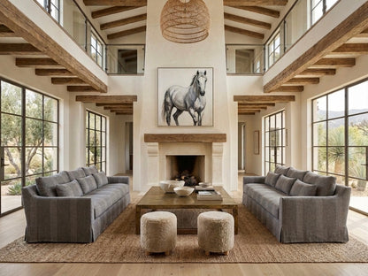 Living room with gray sofas, a coffee table, and a horse painting on the wall.